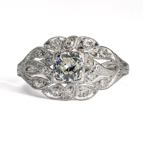 Front view of antique platinum diamond ring with 17 diamonds and hand-pierced openwork design