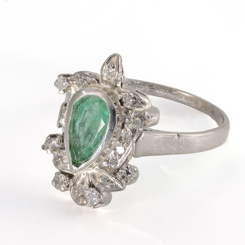 Right three-quarter perspective view of vintage 1940s Retro palladium pear emerald and diamond foliate cocktail ring