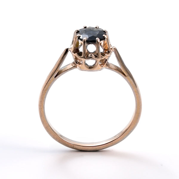 Upright studio shot of a 19th-century French yellow gold sapphire ring against a white background.