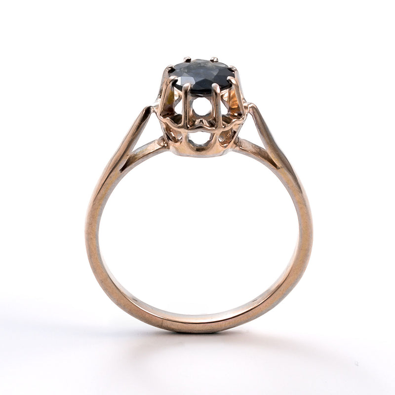 Upright studio shot of a 19th-century French yellow gold sapphire ring against a white background.