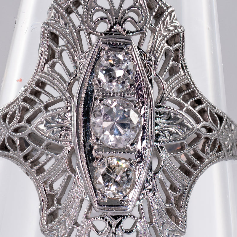 Extreme close-up of natural transitional cut diamonds surrounded by fine Art Deco filigree openwork.