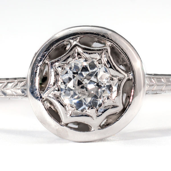 Close-up of a .20ct transitional cut diamond highlighting the unique starburst bezel setting and hand-cut facets.