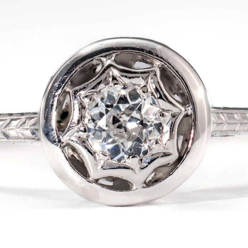 Close-up of a .20ct transitional cut diamond highlighting the unique starburst bezel setting and hand-cut facets.