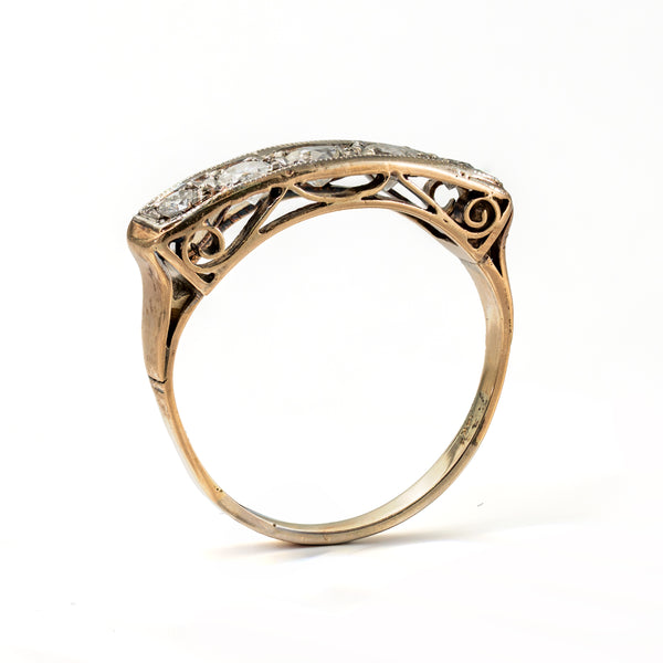 Angled upright view of a transitional Edwardian to early Art Deco five-stone diamond ring