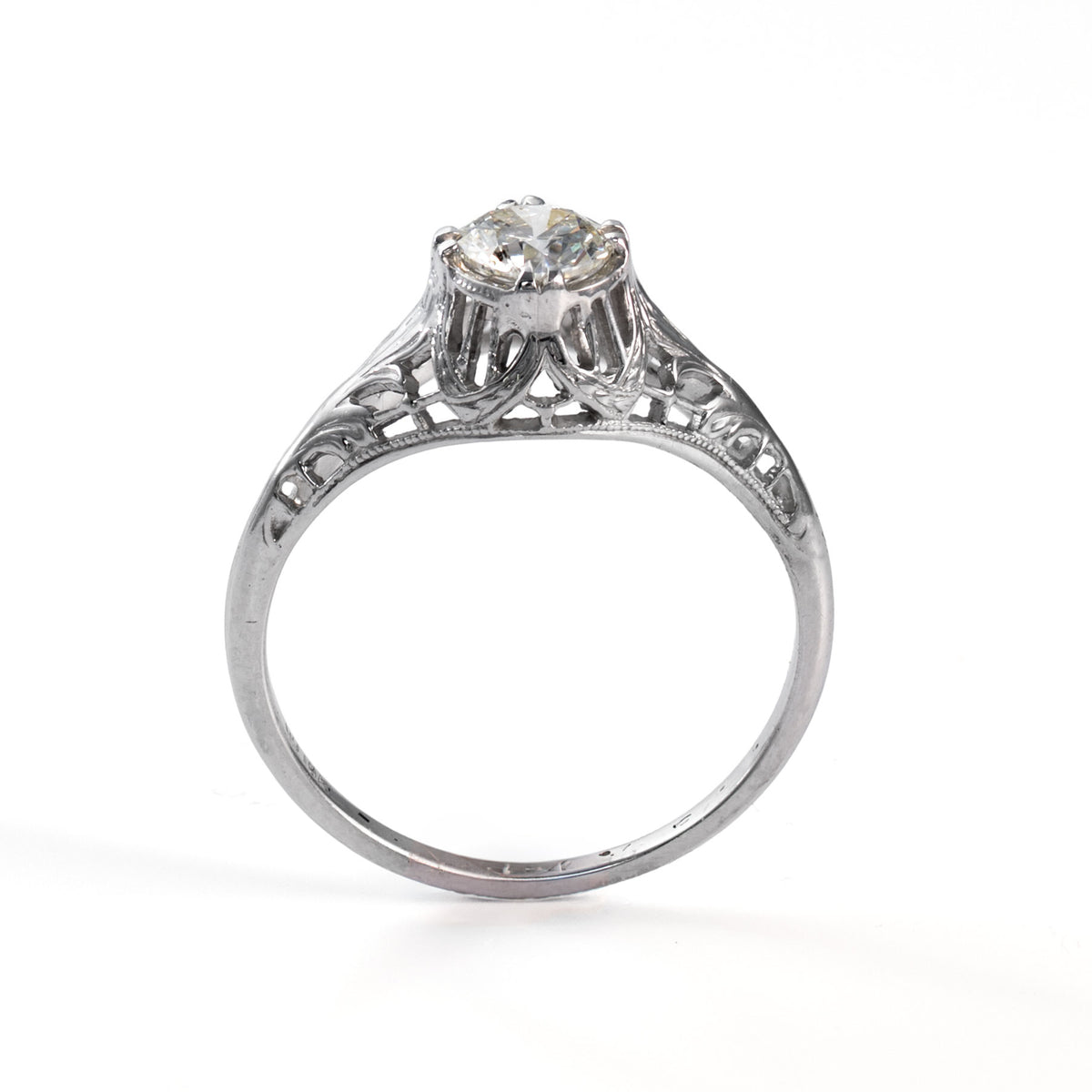 Upright view of a transitional era diamond solitaire ring in white gold