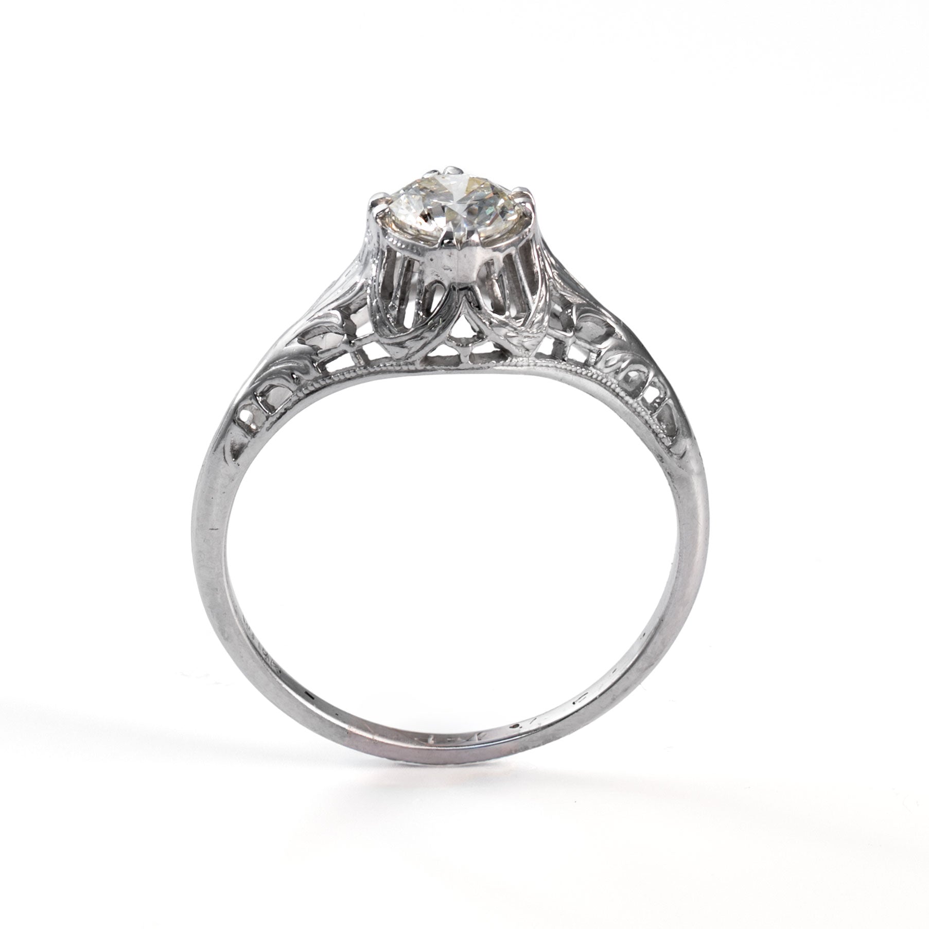 Upright view of a transitional era diamond solitaire ring in white gold