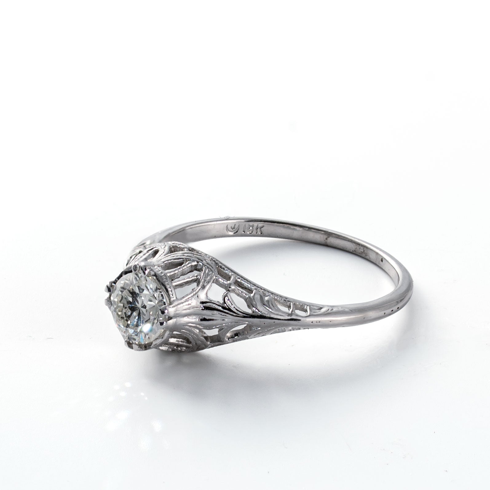 Right side profile of an Old European Cut diamond ring with pierced Art Deco detailing