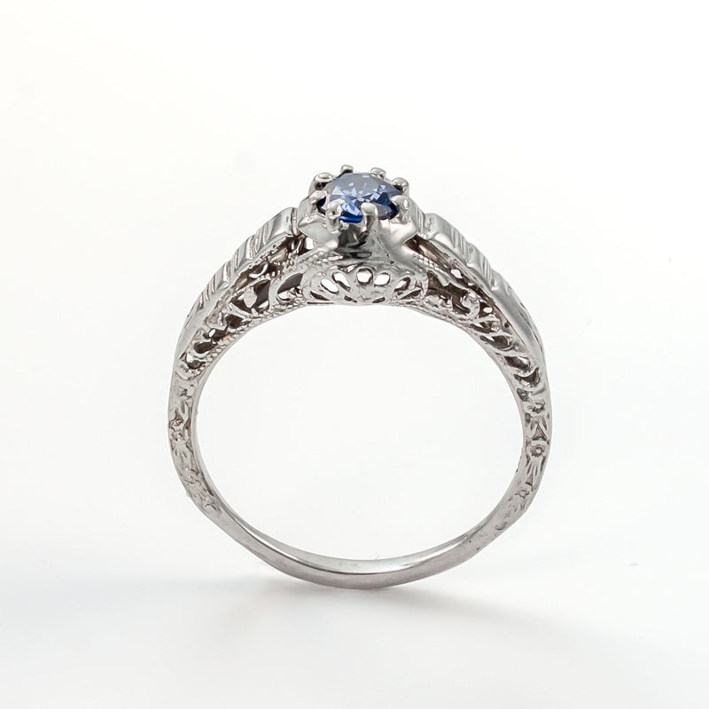 Upright angle of antique sapphire ring highlighting open gallery and handcrafted details