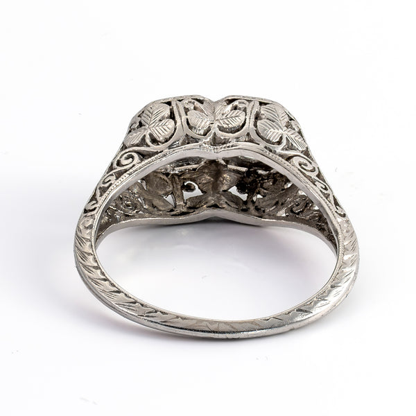 Rear architectural perspective of a vintage platinum bypass ring revealing hand-sawn clover motifs and detailed gallery piercing beneath the diamond settings.