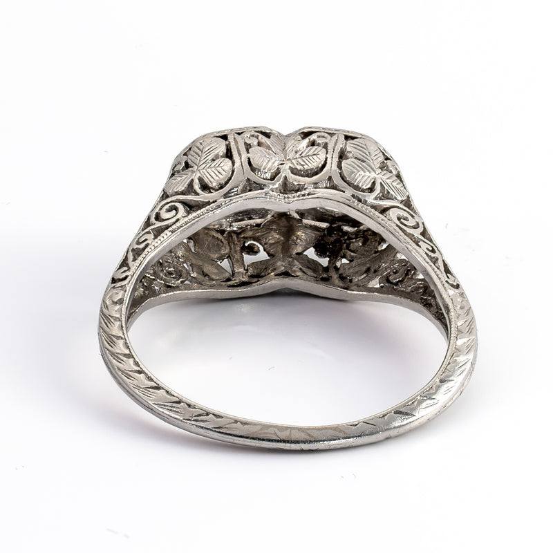 Rear architectural perspective of a vintage platinum bypass ring revealing hand-sawn clover motifs and detailed gallery piercing beneath the diamond settings.