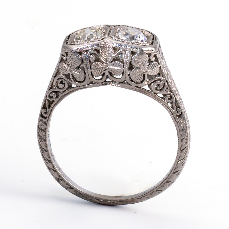 Full vertical profile of an antique platinum engagement ring showing the continuous outer shank engraving and raised hand-pierced gallery architecture.