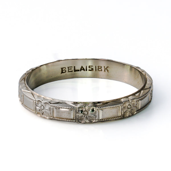 Antique Belais 18K white gold floral band size 8.5 showing interior hallmark and 3.6mm wide exterior pattern.
