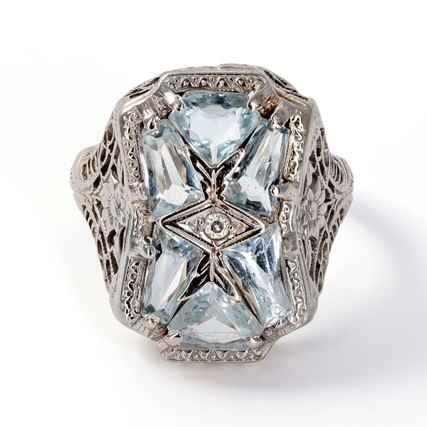 Authentic 1920s Art Deco 18K white gold ring featuring six custom-cut geometric aquamarines and center Old European cut diamond.