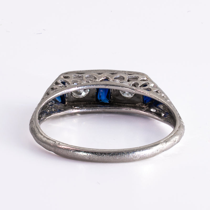 Reverse or underbridge view of the ring setting, highlighting the intricate pierced platinum gallery and the secure gemstone settings typical of late Art Deco jewelry.