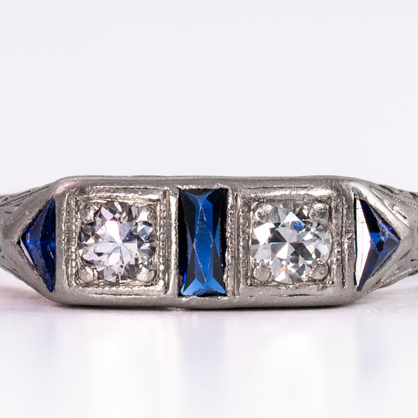 Extreme close-up of the well-matched old-mine diamonds and natural dark blue sapphires, showcasing the graphic sophistication of circa 1930 geometric jewelry design.