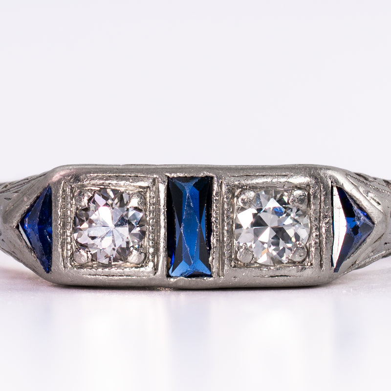 Extreme close-up of the well-matched old-mine diamonds and natural dark blue sapphires, showcasing the graphic sophistication of circa 1930 geometric jewelry design.
