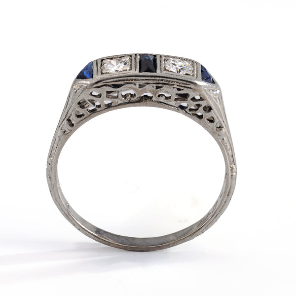 Full standing profile view of an authentic 1930s diamond and sapphire ring, illustrating the detailed engraved shank and the low, wearable design profile.