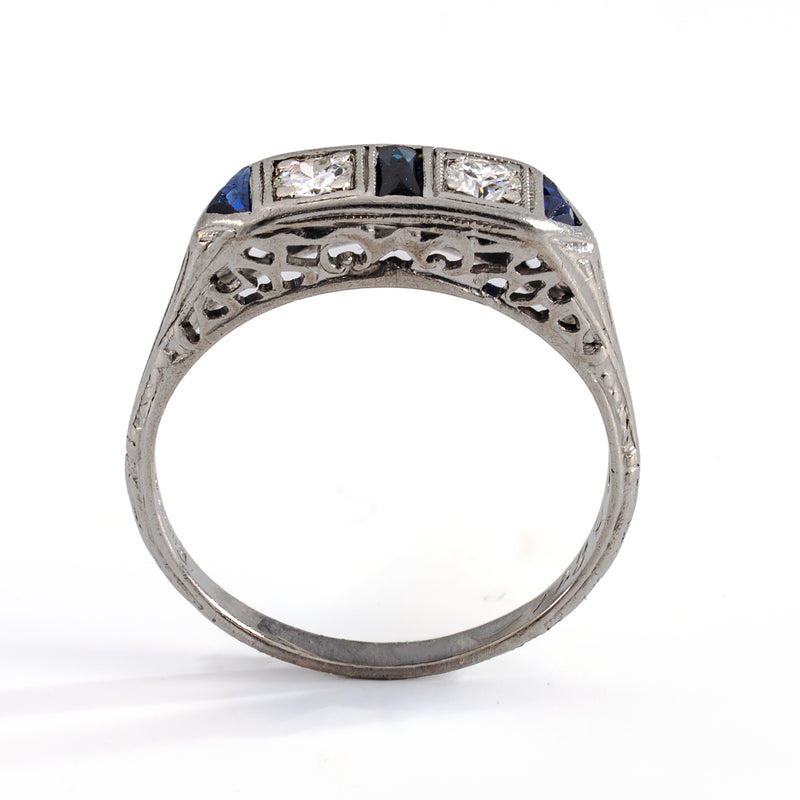 Full standing profile view of an authentic 1930s diamond and sapphire ring, illustrating the detailed engraved shank and the low, wearable design profile.