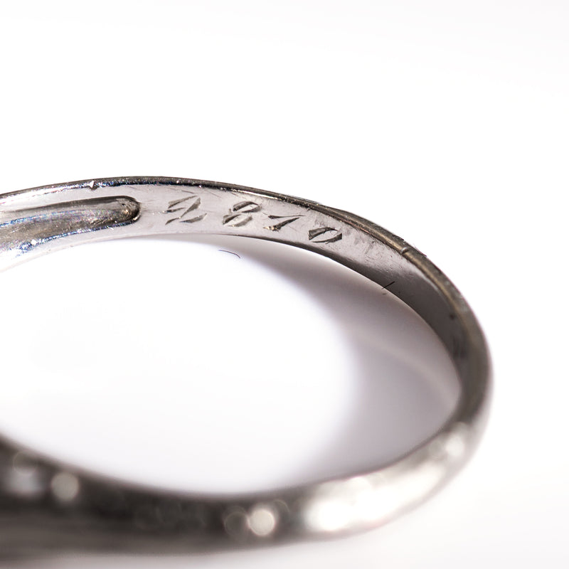Hand-engraved serial or inventory numbers inscribed inside the band of a vintage circa 1930 platinum engagement or anniversary ring.