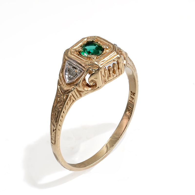 Standing angled profile of the vintage gold ring showing the low profile setting height and architectural side piercings.
