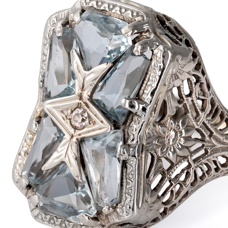 Extreme close-up macro view showing precision faceting on custom-cut aquamarines and hand-finished white gold settings.