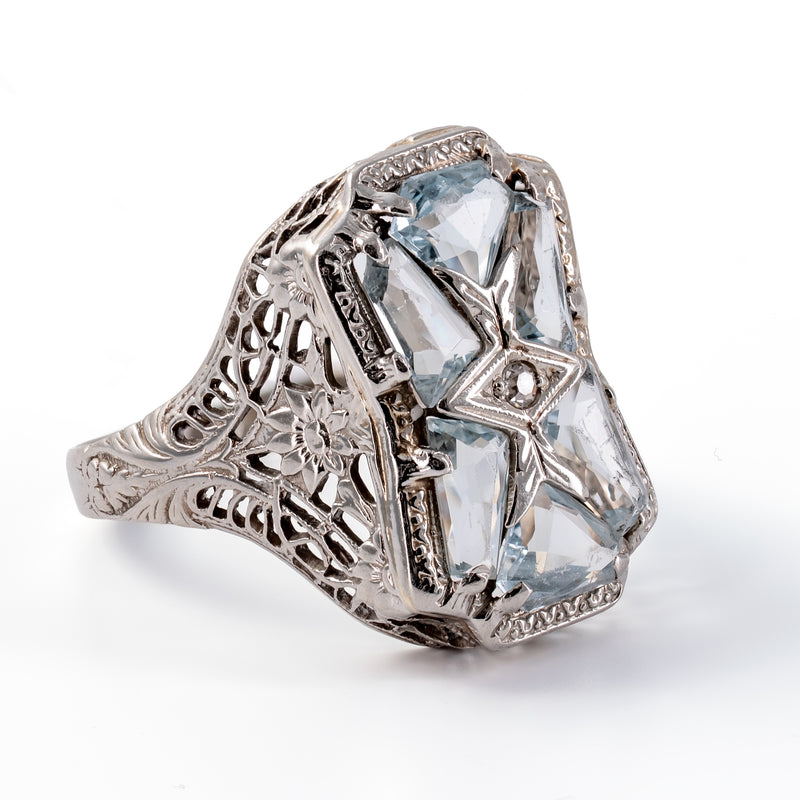 Left three-quarter perspective of an antique Art Deco aquamarine and diamond dinner ring with openwork mounting.