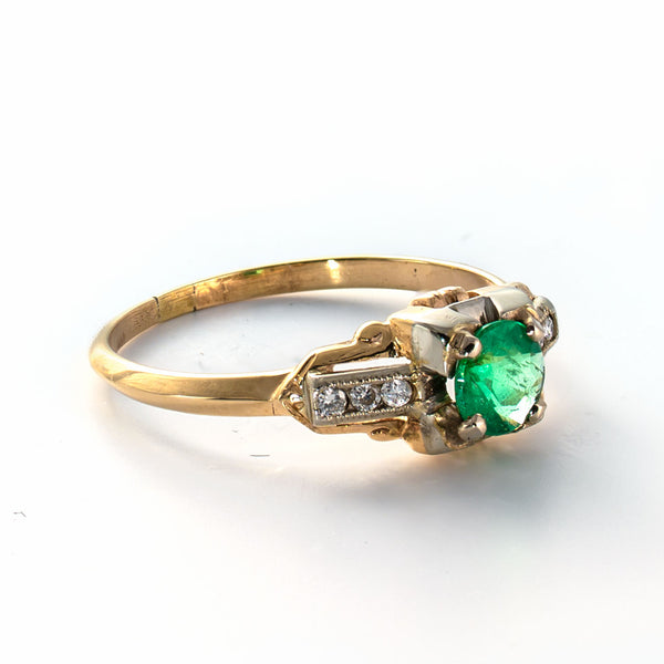 Gold ring with a green gemstone on a white background