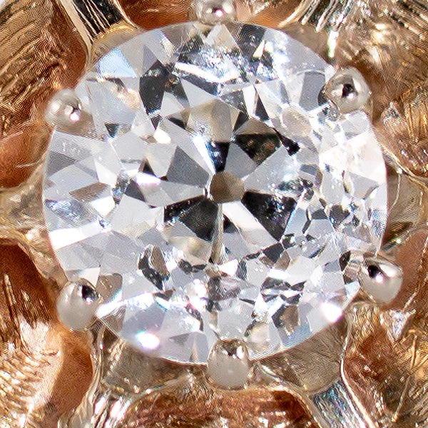 Macro close-up of natural 0.45 carat Old European Cut diamond showing broad facets and open culet