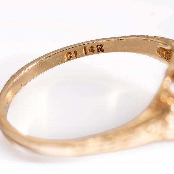 Macro close-up of the maker's hallmark and 14K gold purity stamp stamped inside the interior ring shank.