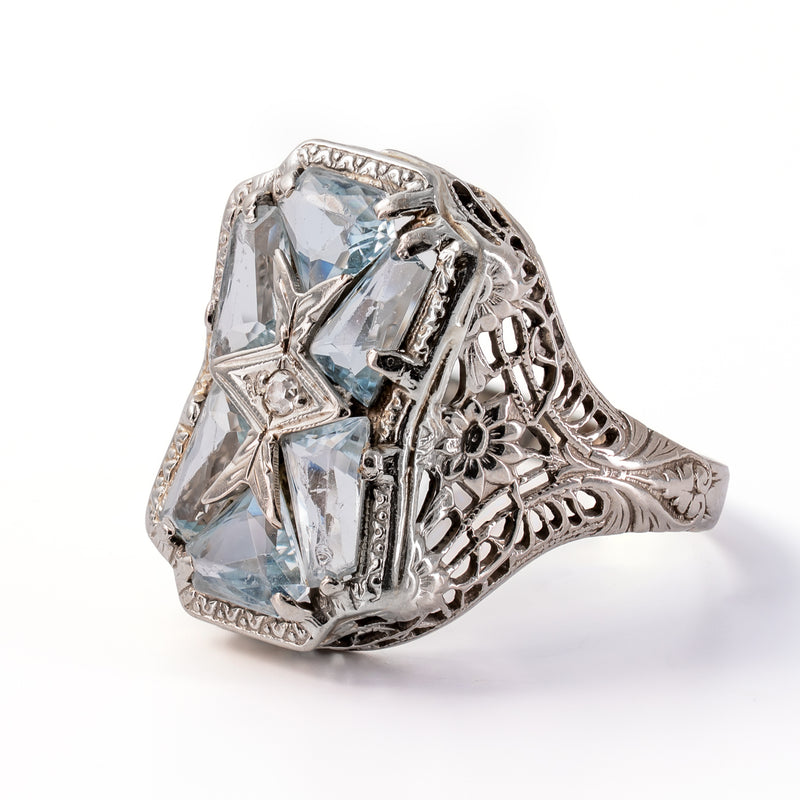 Right side view highlighting the geometric face, floral filigree openwork, and engraved shoulder details.