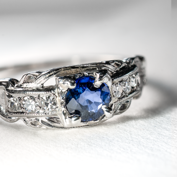 close up detailof royal blue sapphire and singe cut diamonds.
