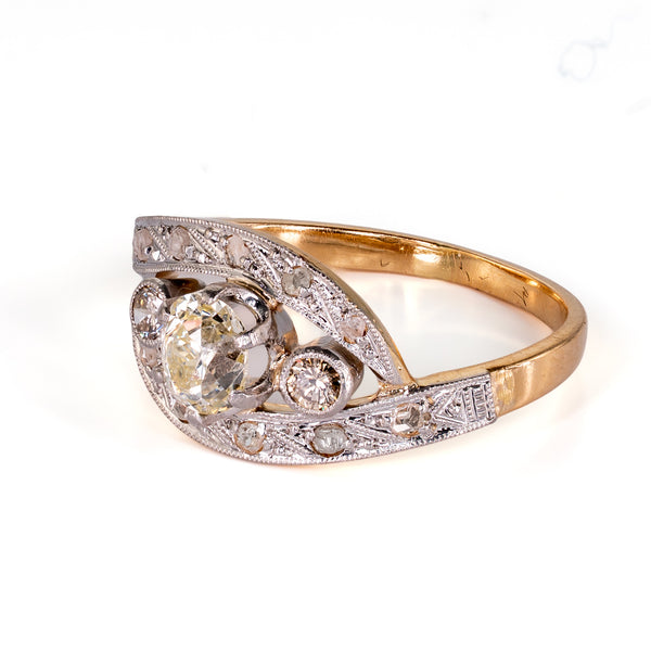 High-angle side perspective focusing on the milgrain edges, engraved platinum-topped shoulders, and asymmetrical flowing curves.