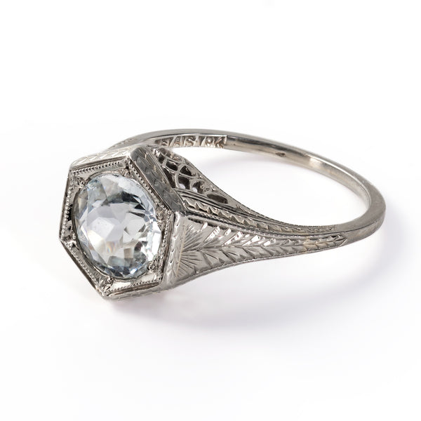 Side profile view of a vintage Belais aquamarine solitaire ring showing the gallery openwork and tapering 18K band.