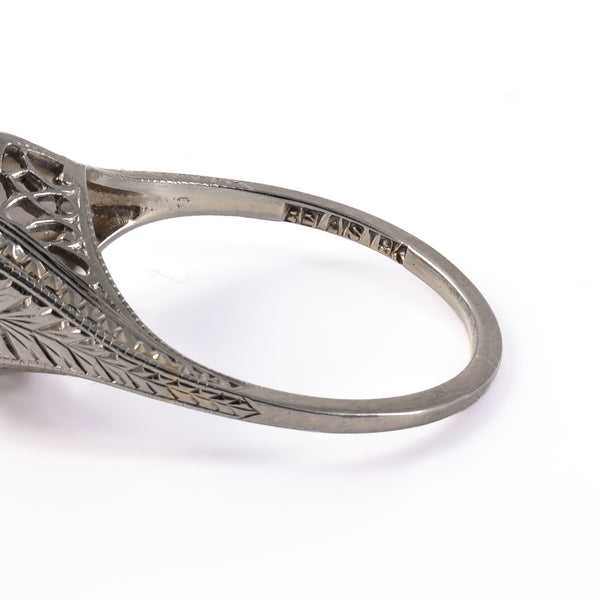 Close-up of the original maker's mark stamp BELAIS 18K on the inner shank of an antique Art Deco ring.