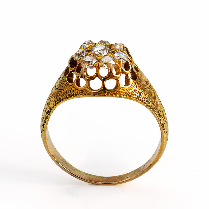 Victorian ring highligting hand engraving pierced gallery and 8 old mine cut diamonds.