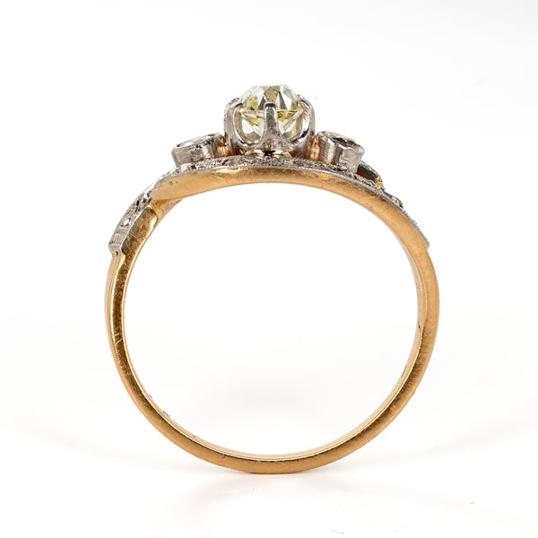 Upright side profile illustrating the height of the raised central prong setting and the curvature of the yellow-gold shank.