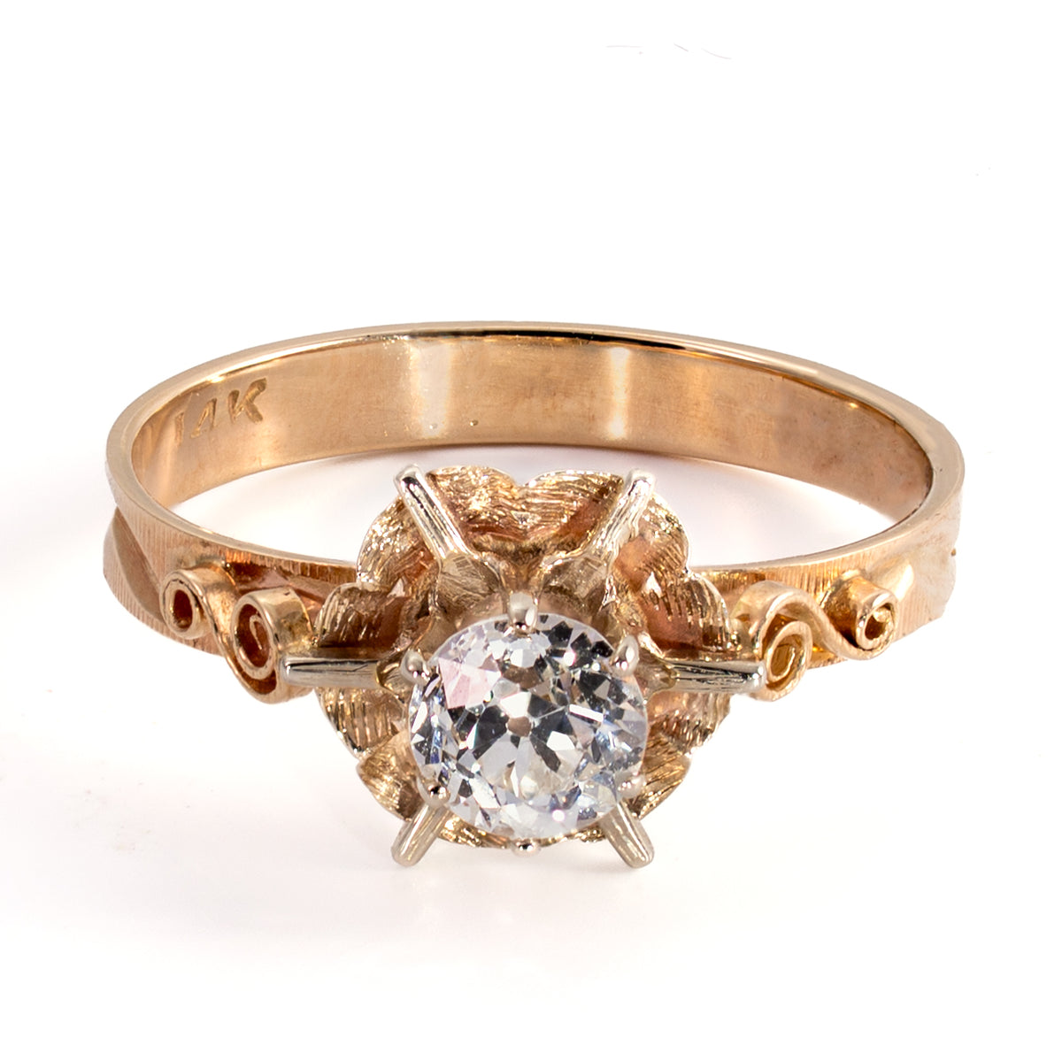 Three-quarter elevated view of Late Art Deco floral ring with 0.45ct OEC diamond and openwork scroll shoulders