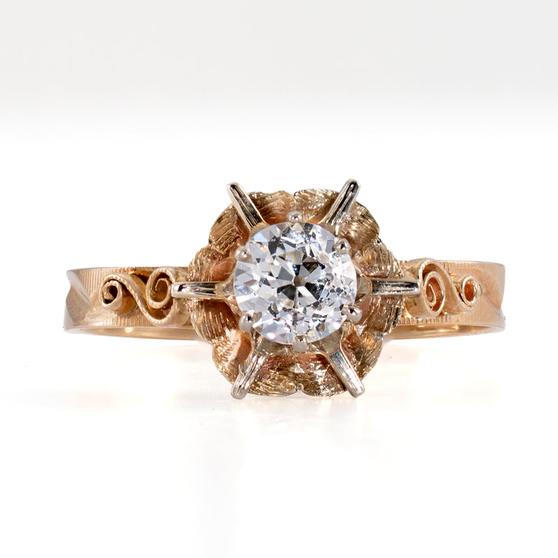 Direct top-down view of sculpted 8mm floral buttercup head with center OEC diamond and white-metal prongs