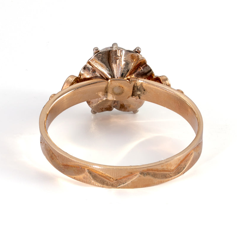 Underside view of 14K gold ring highlighting the continuous carved chevron engraving around the back of the band
