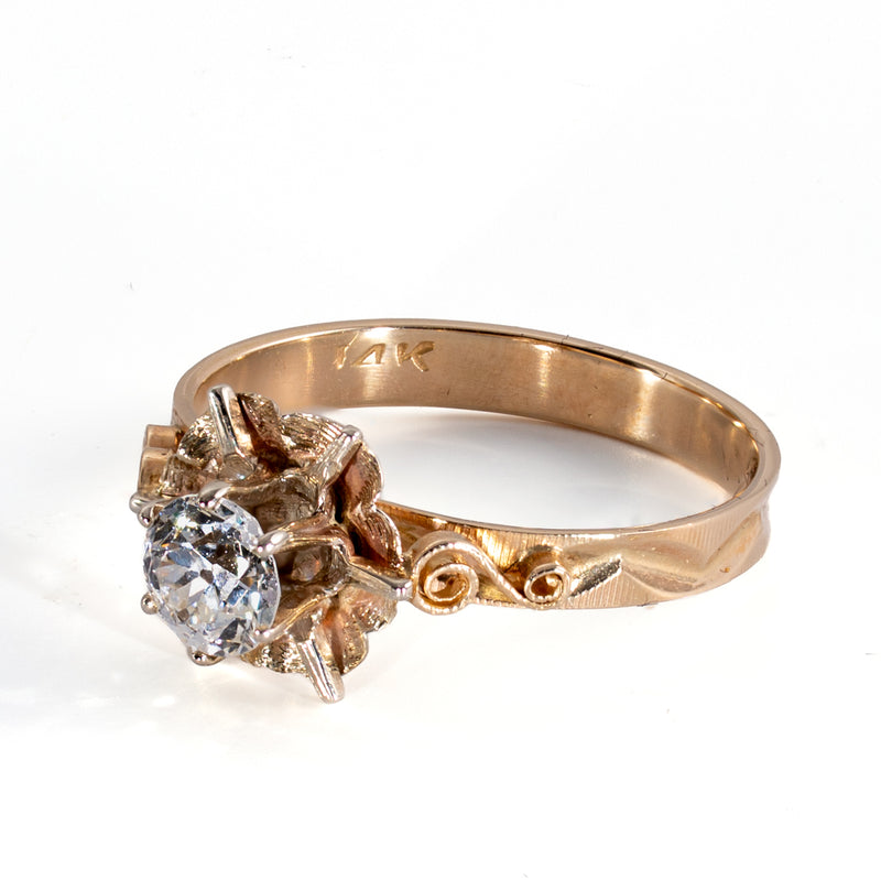 Side view of vintage diamond buttercup ring showing textured petals and dimensional S-scroll shoulders